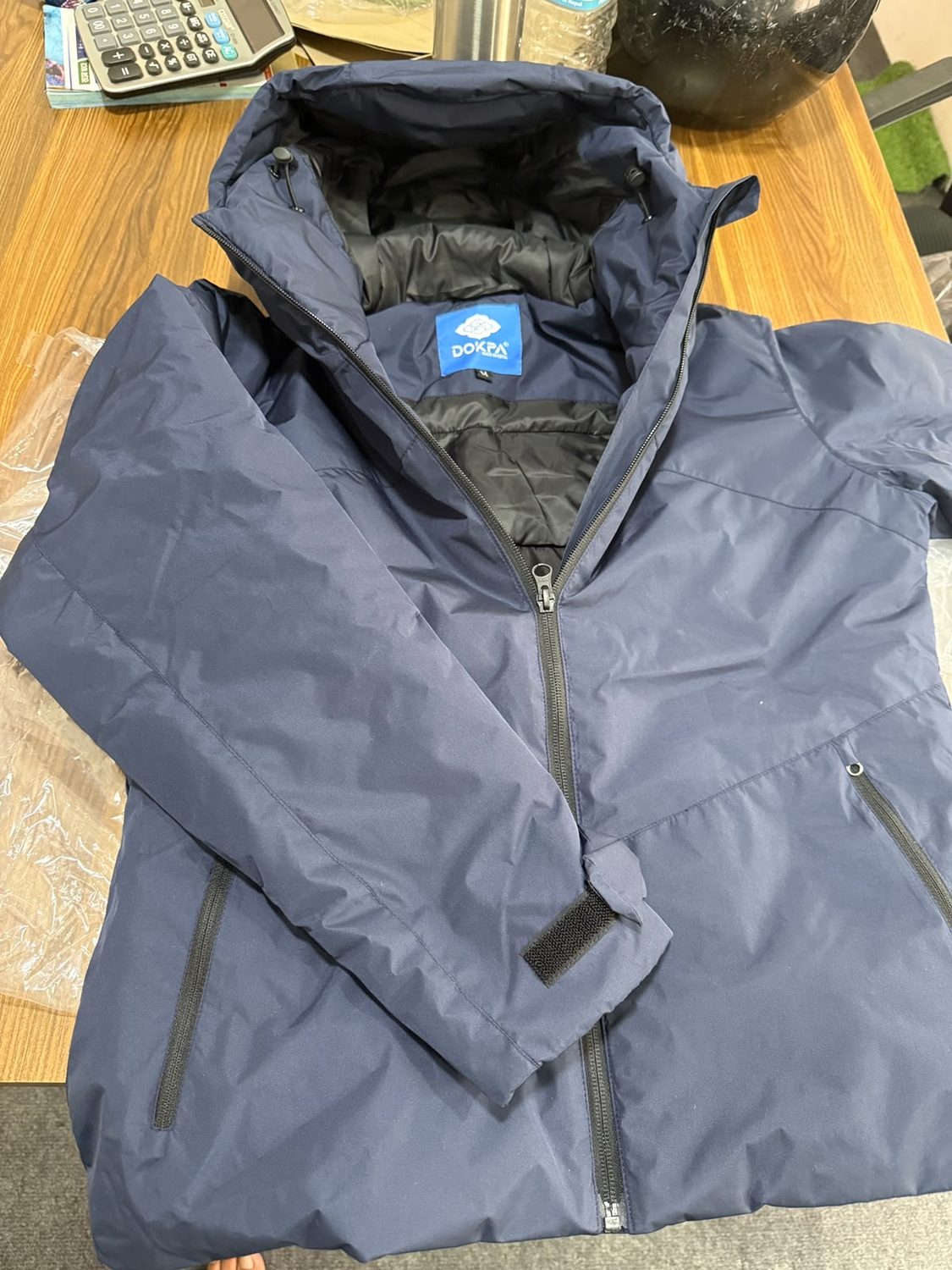 Close view of a jacket collar with the blue Dokpa label stitched inside it